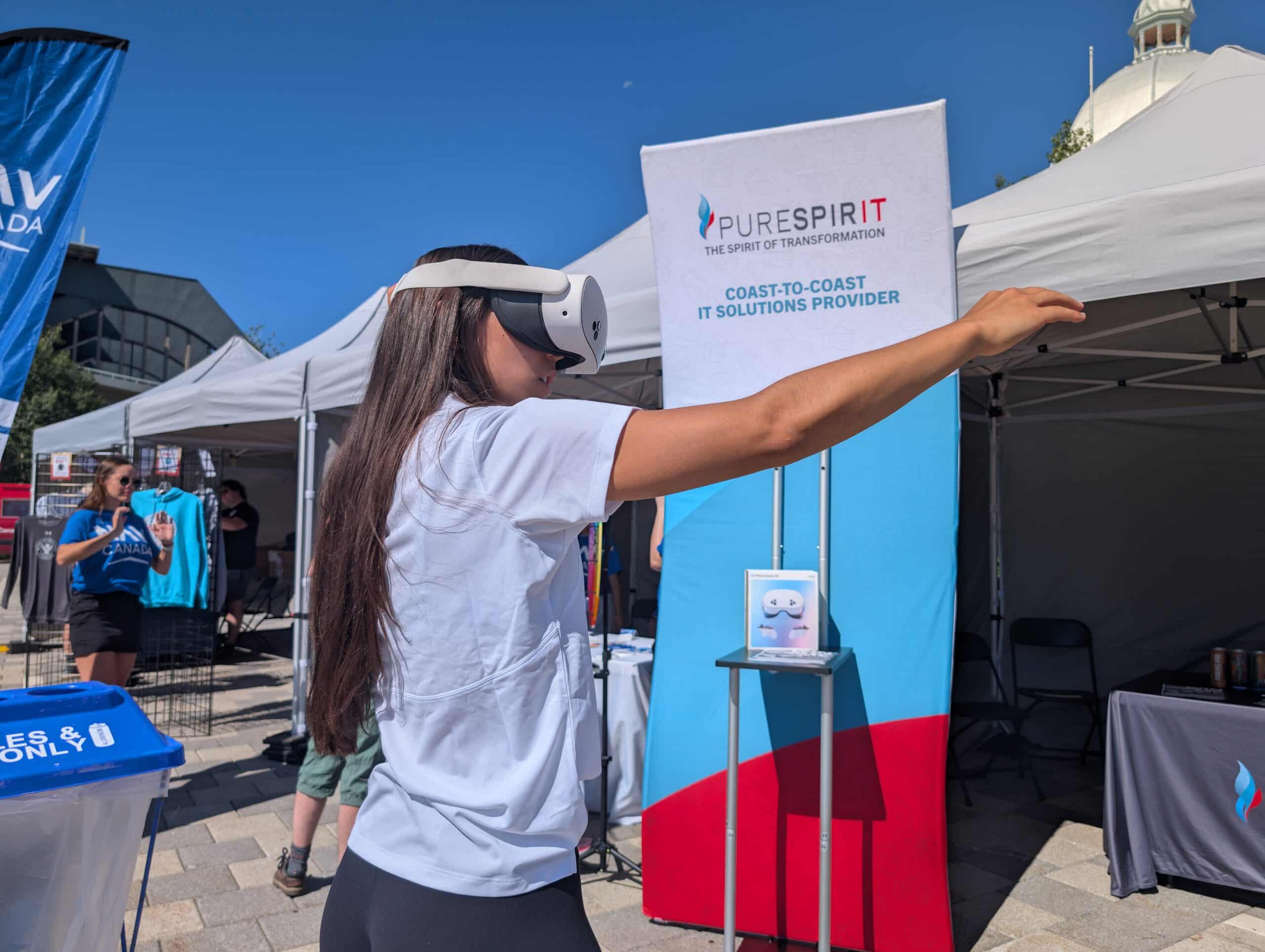 Person wearing VR headset in front of PureSpirIT banner.